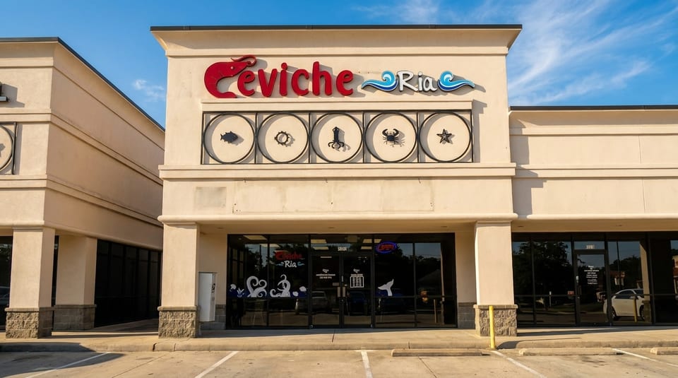 Exterior of Ceviche Ria restaurant with a red and blue sign, and seafood icons above the entrance.